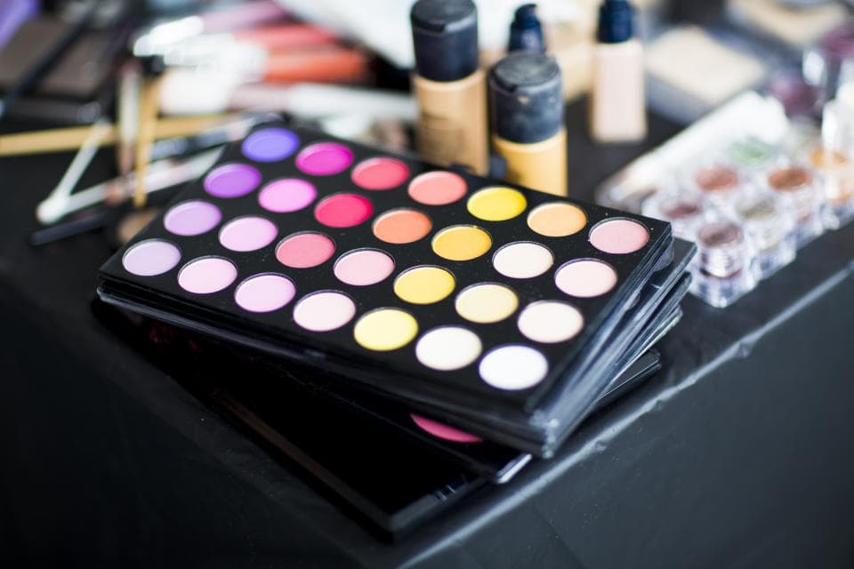 Colorful makeup palette with eyeshadows and brushes