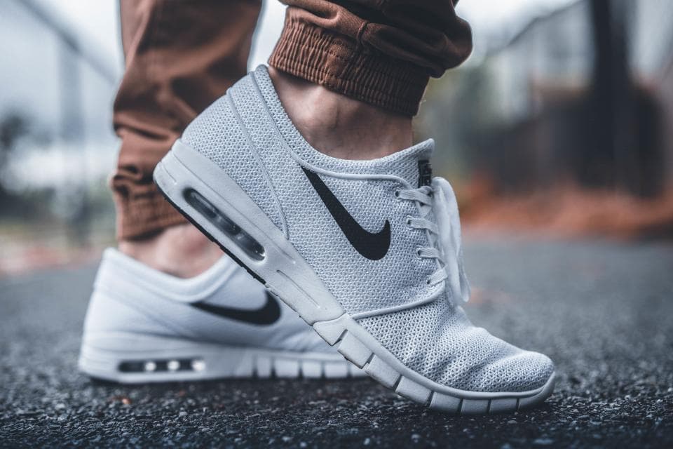 Close-up of running sneakers on a city pavement