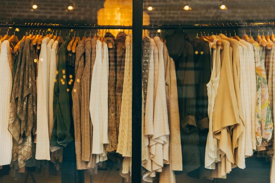 Rack of casual clothes on hangers in a shop